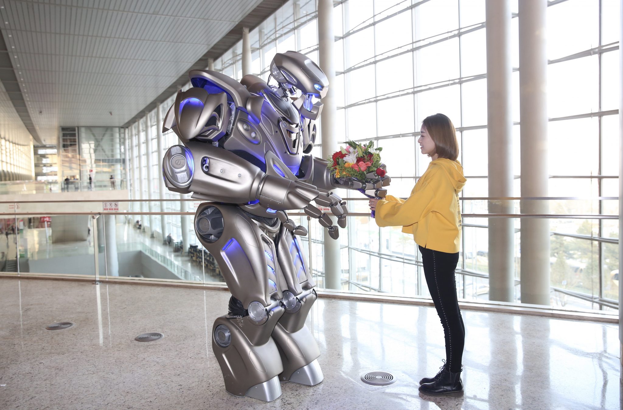 Titan the Robot gives a girls some flowers in China.
