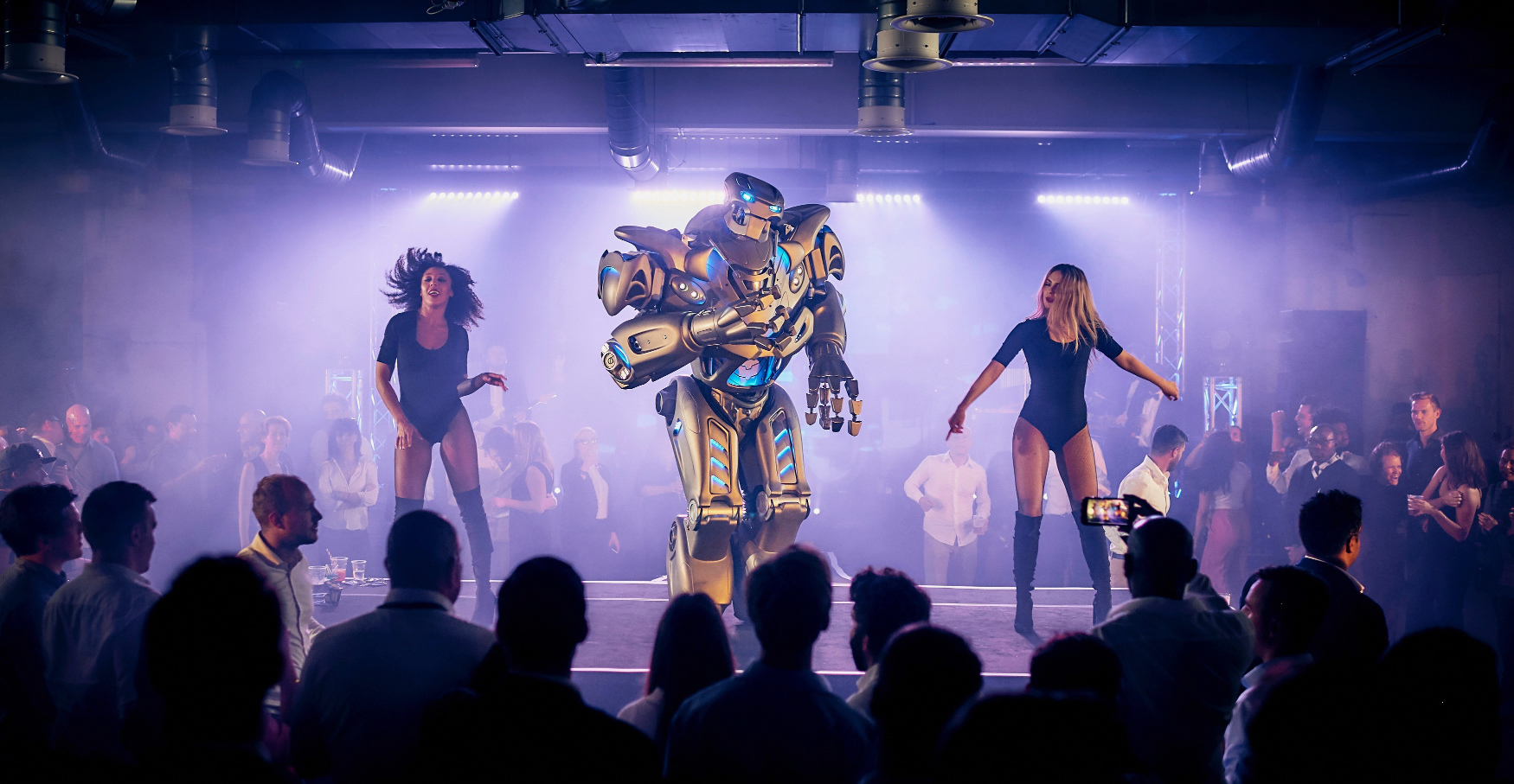 Titan the Robot dances on stage at a corporate event at the Oval Cricket Ground.